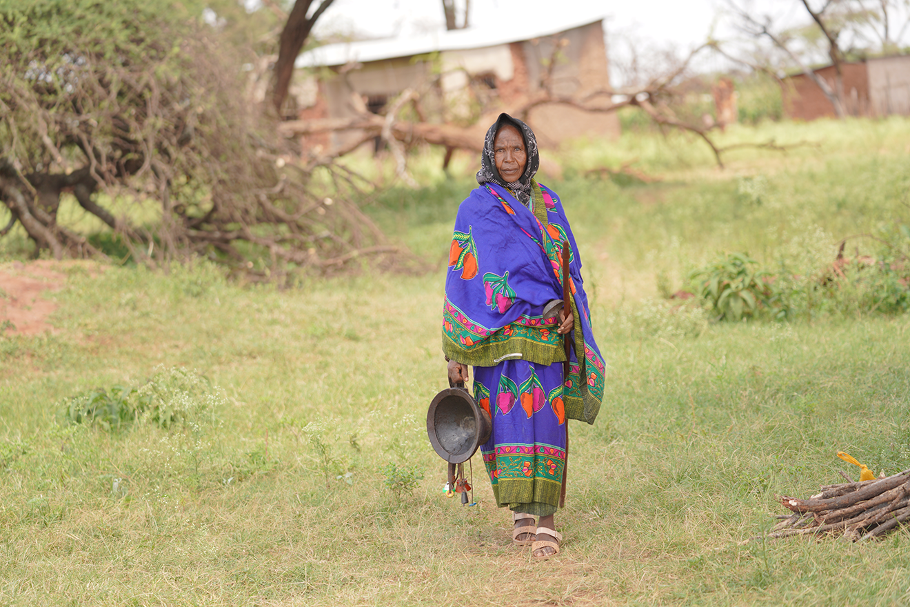 An Ethiopian woman walks toward the camera from a distance.