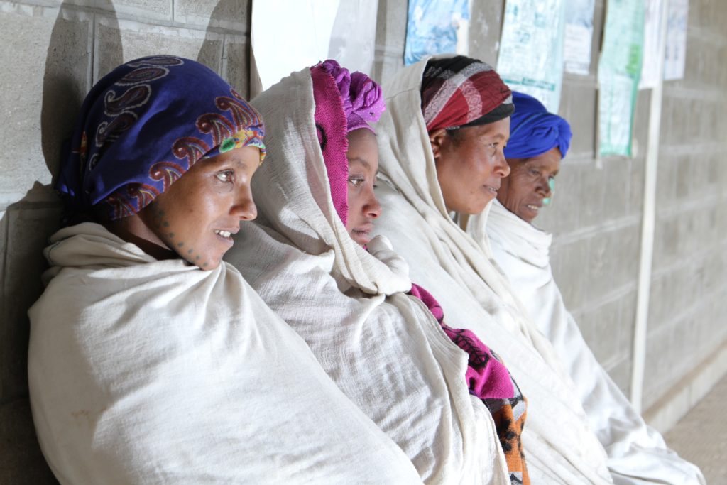 Four women sitting outside a building in Ethiopia