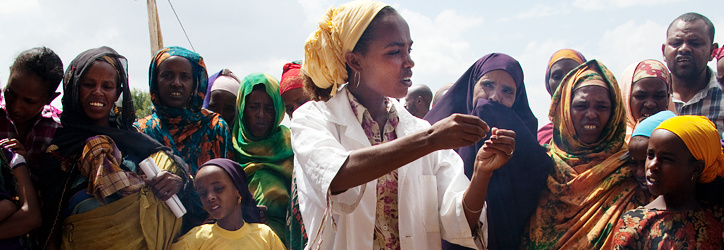 Girl showing something to a crowd of people