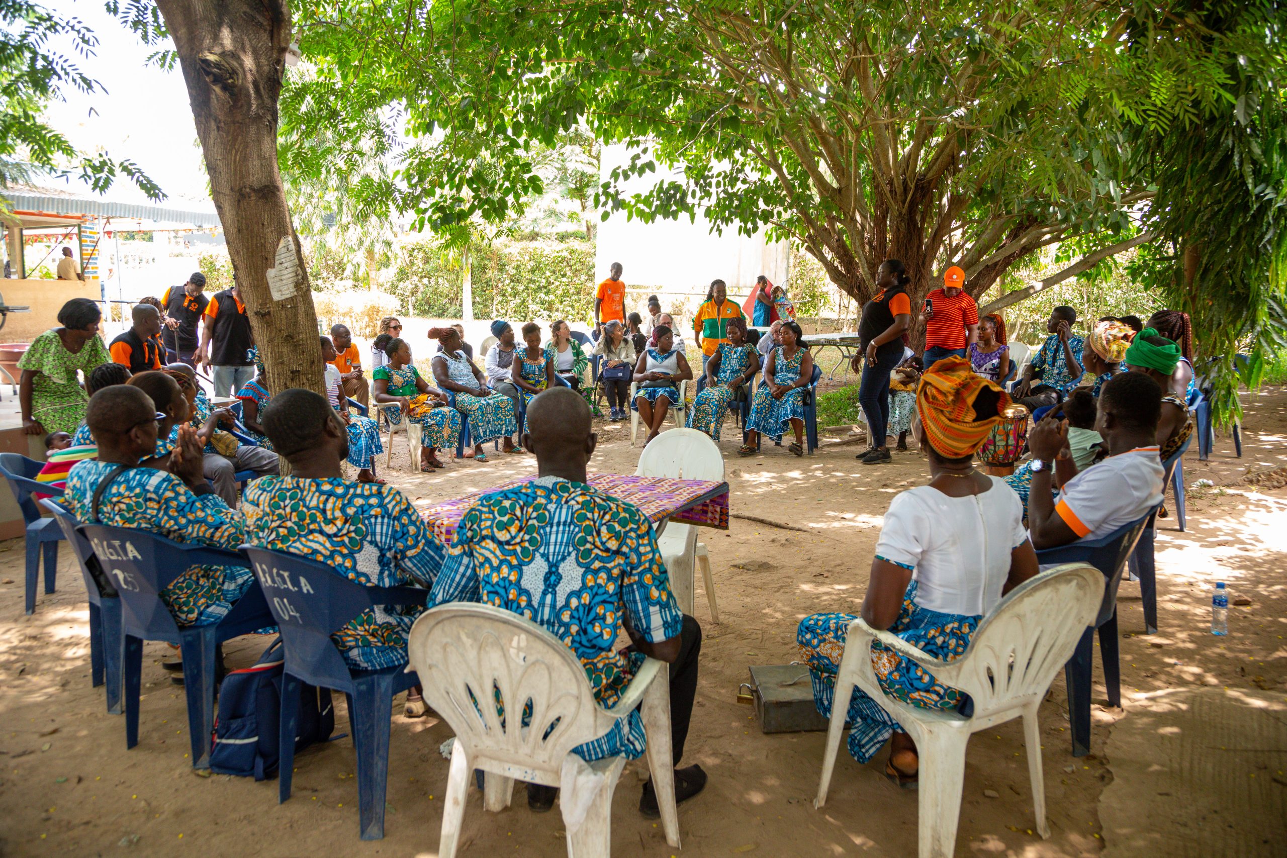 Circle of people sitting learning about Enhancing the SRHR, Safety, and Livelihoods of Women and Girls in Côte d’Ivoire
