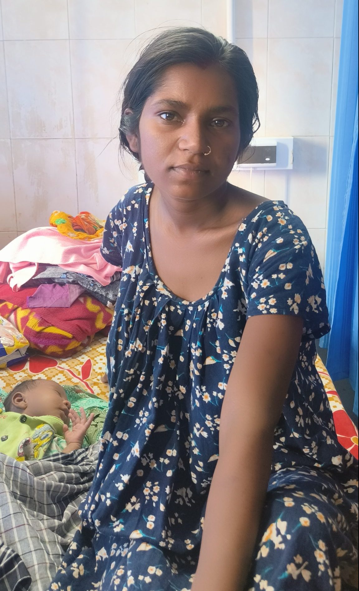 Woman with newborn baby girl in India