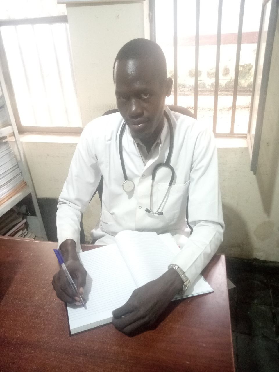 A medical provider from Gambella, Ethiopia sits in his office.