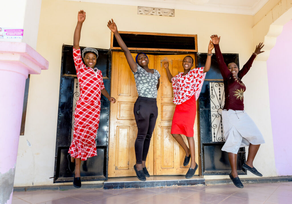 A group of four women jump for joy in Tanzania.