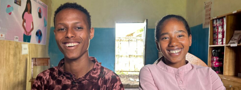 Smiling teenaged boy and girl in a classroom in Ethiopia.