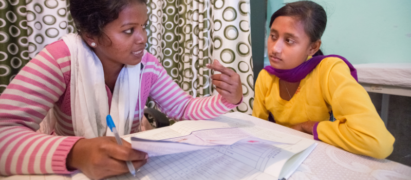 Health center in India. Healthcare worker and teenager meet to discuss contraceptive options.