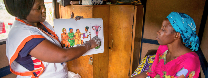A healthworker in Kenya shares reproductive health information with a client. Photo credit: Images of Empowerment.