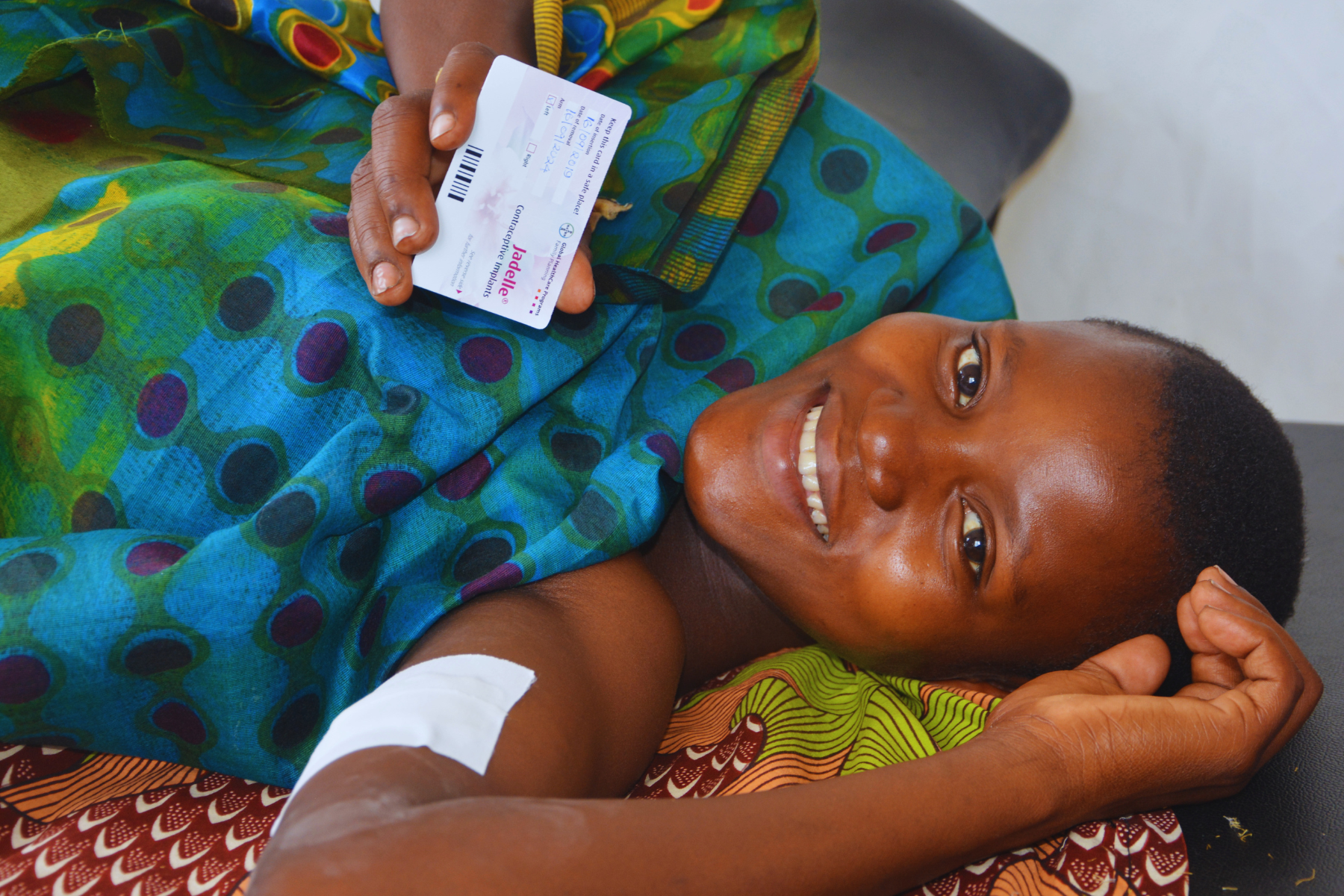 Smiling patient proudly shows off her contraceptive implant. Tanzania.