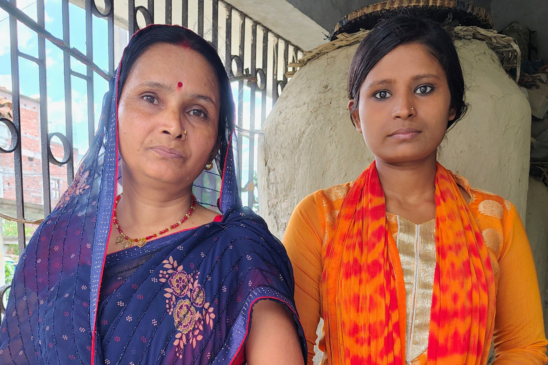 Rani and Pallavi, mother and daughter, stand proudly together in Bihar, India.