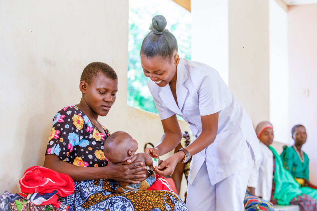 Healthcare worker meets with mother and infant.